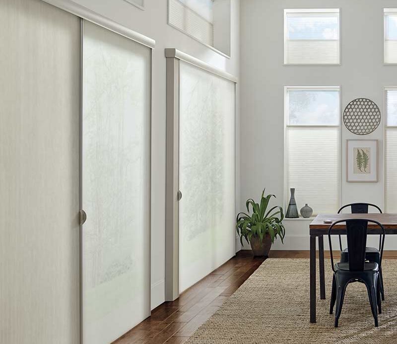 dining room with cream honeycomb shades on sliding glass doors