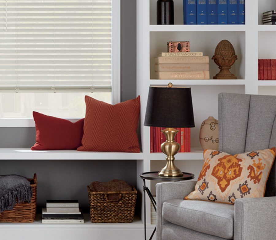 grey armchair with orange pillow and hunter douglas faux wood blinds Cleveland