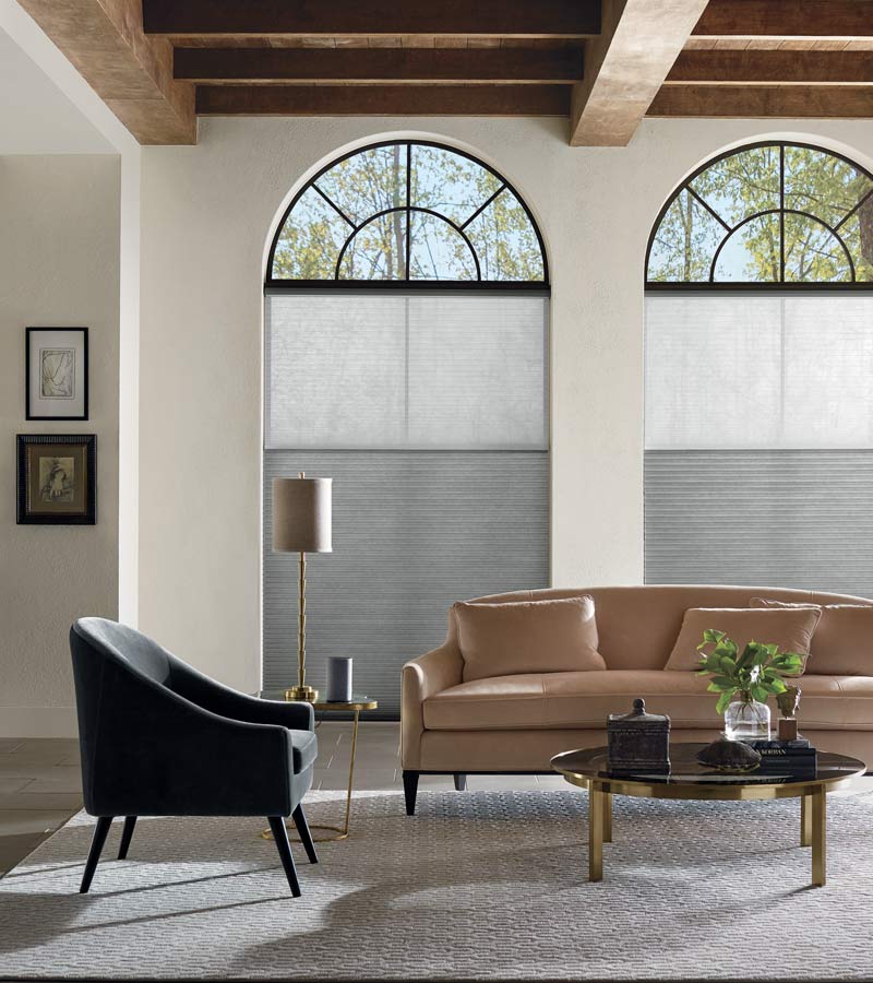brown leather couch in neutral living room large rounded windows in Cleveland 44125
