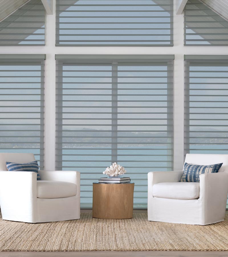 Coastal living room with two white accent chairs and large windows in Rocky River 44116