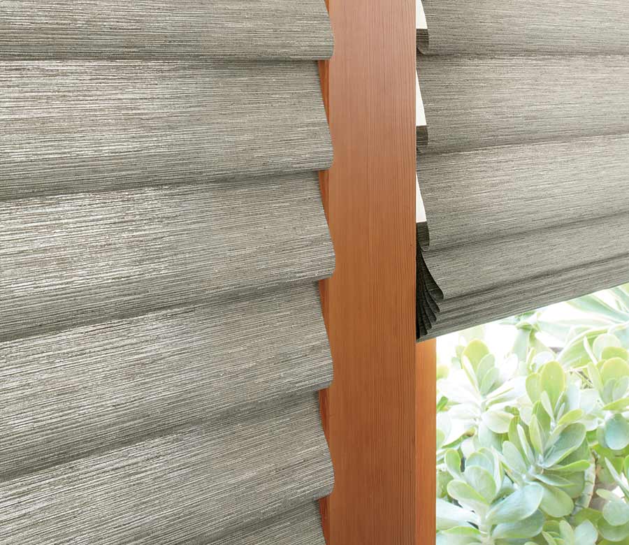 gray fabric roman shades on glass patio doors