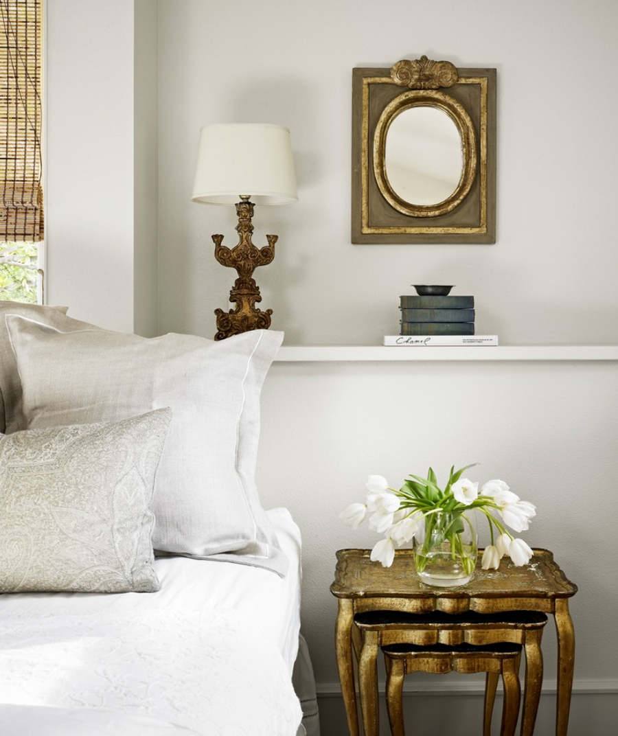 antique brass side tables and wall frames in living room