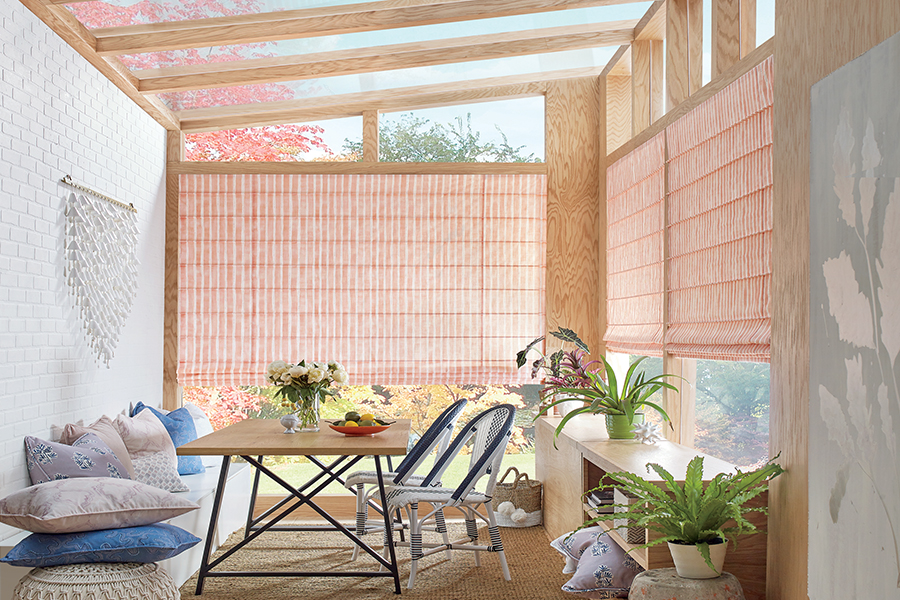 sunroom with vibrant coral color fabric roman shades