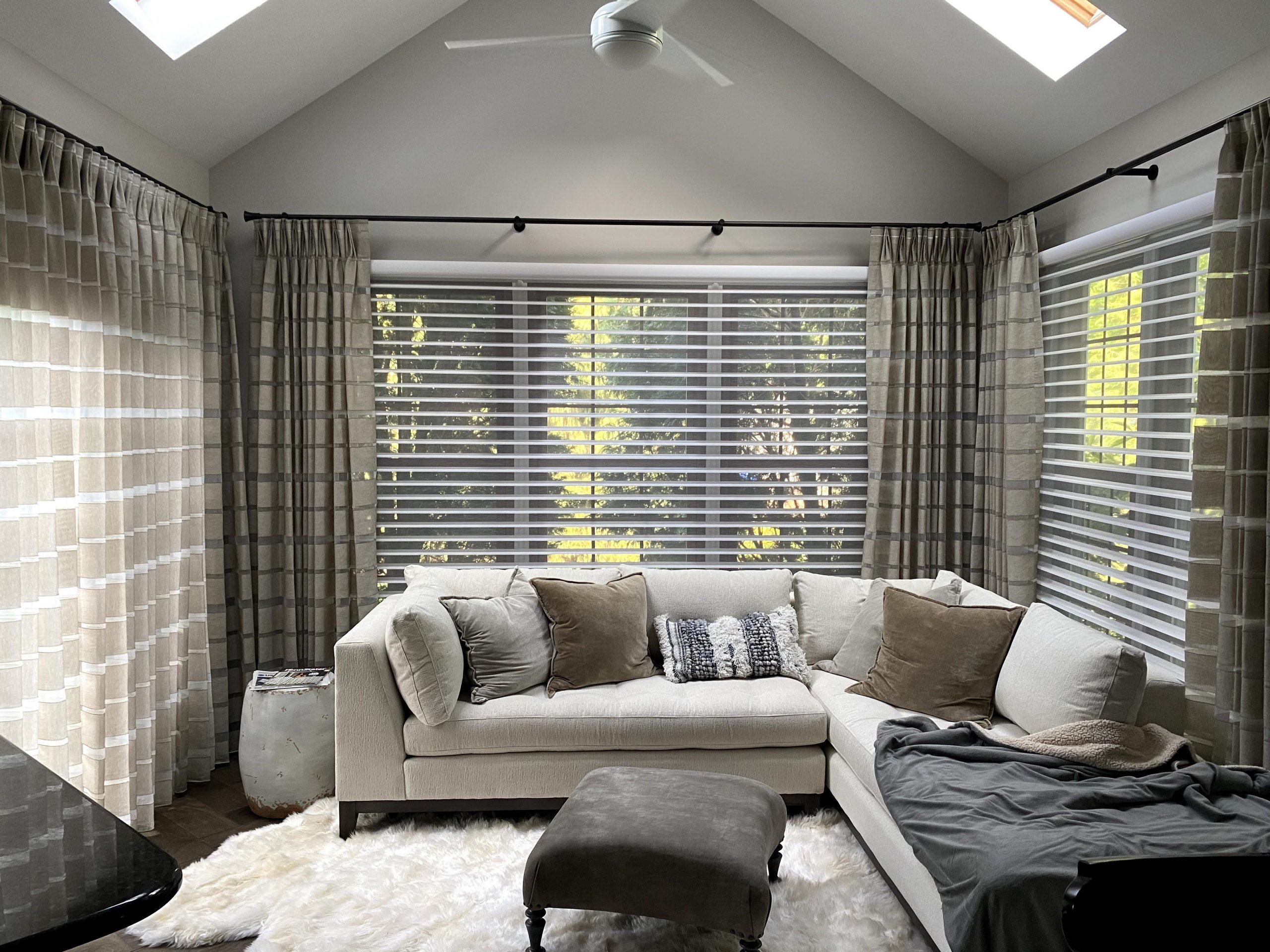 angled ceiling living room with large windows covered with silhouette shades and plaid draperies in Rocky River OH