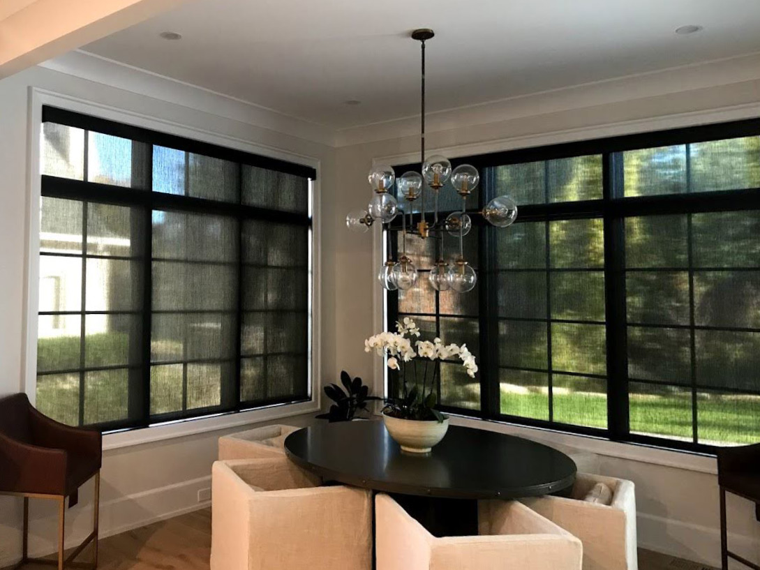large windows with black trim covered with see through black screen shades in Chagrin Falls OH