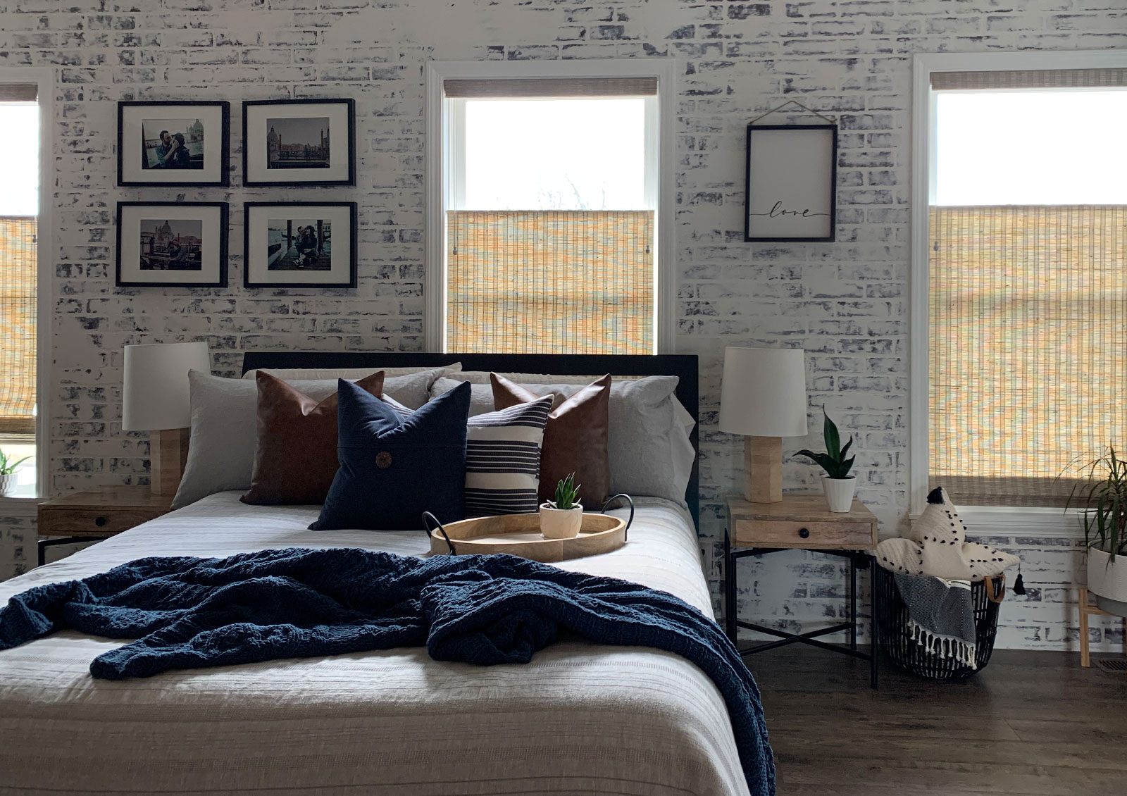 master bedroom faux brick wall with top down woven wood shades