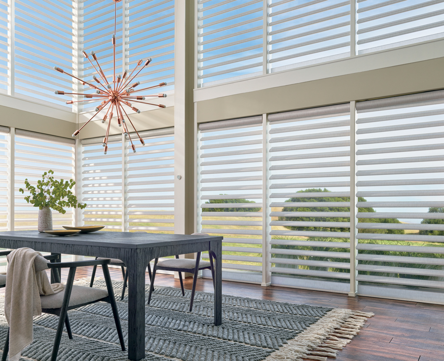 tall floor to ceiling windows in dining room covered with pirouette sheer shades in Rocky River OH