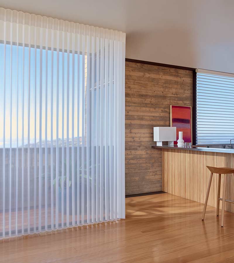 Vertical sheer shades on patio window next to custom bar space Cleveland, OH