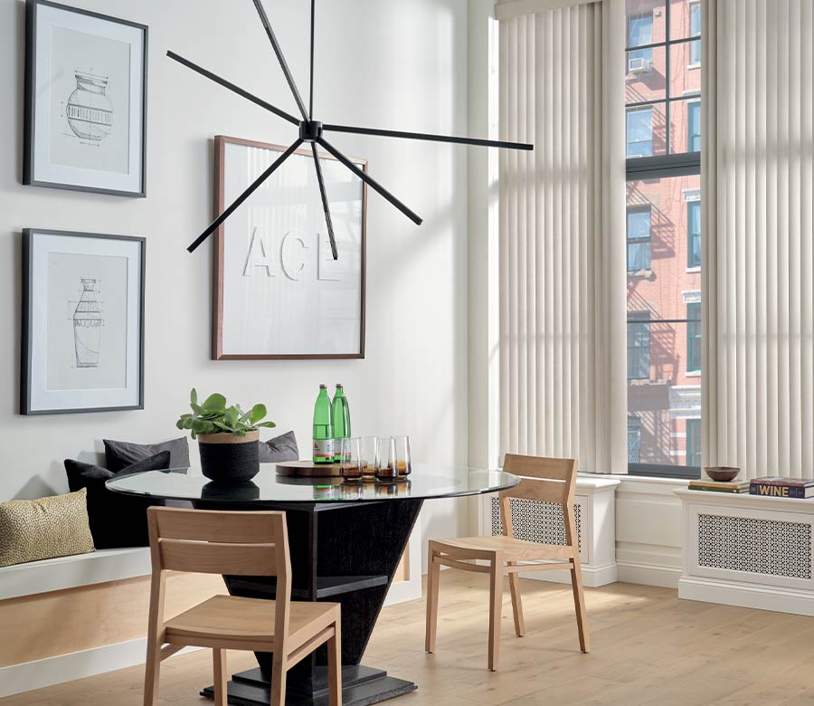 apartment living space with floor to ceiling window shades, white oak floors, and dining room table