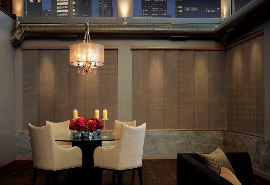 Gliding panels on wall of large windows