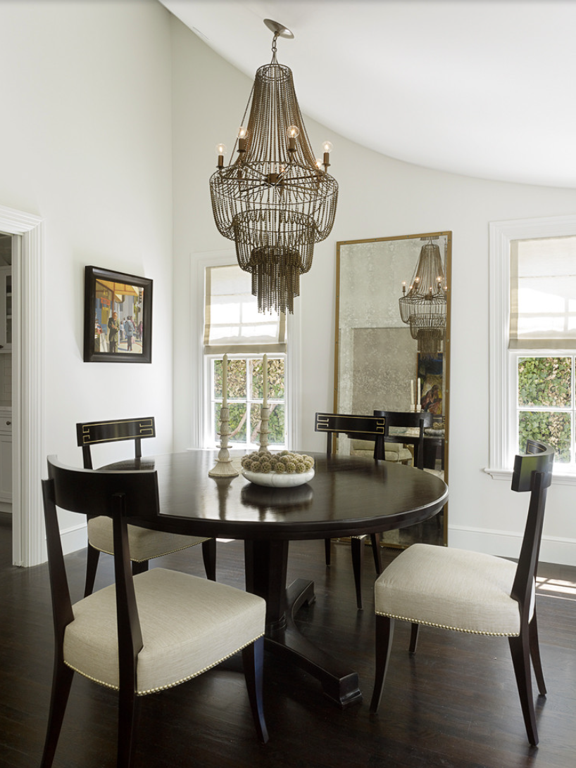 dining room with large mirror can make your space look larger