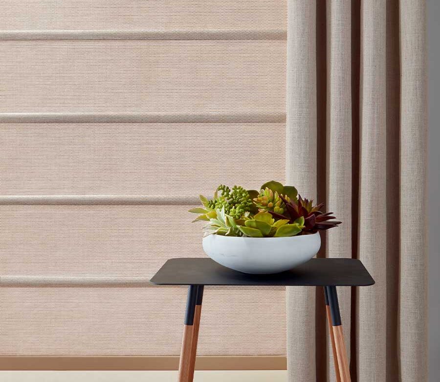 side drapery panel next to soft copper hued window shade