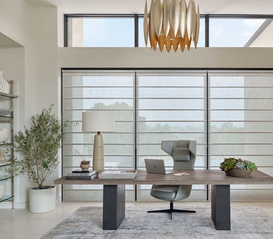 modern executive office with floor to ceiling windows, covered in soft architectural shades that look like romans