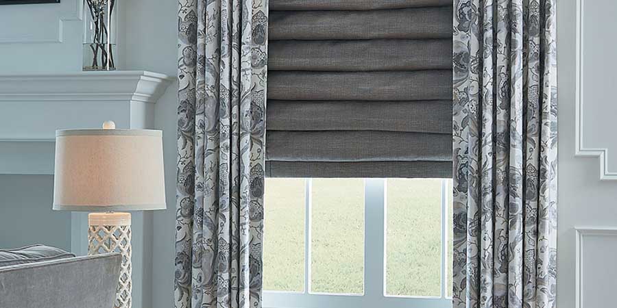 layered fabrics at the window with roman shades and drapery in Solon OH home