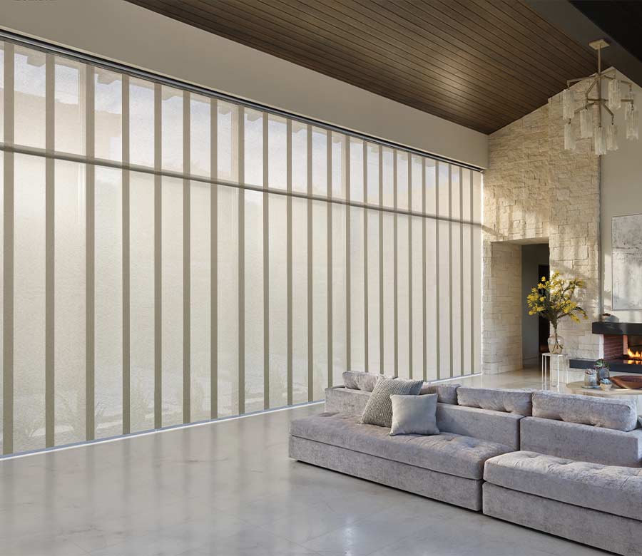 Lodge inspired home with floor to ceiling windows with soft fabric shades