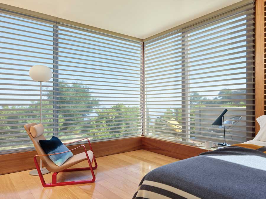 Silhouette® Windows Shades over floor to ceiling windows in a modern bedroom in Beachwood OH