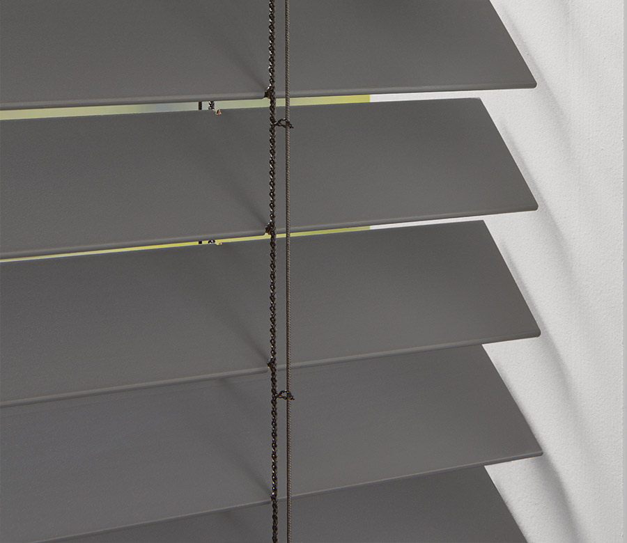 up close detail of slats of blinds in soft matte gray color