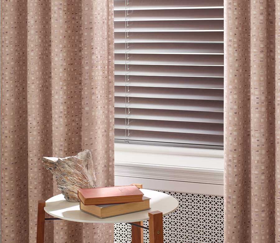 composite blinds next to layered pink draperies in Chagrin Falls OH