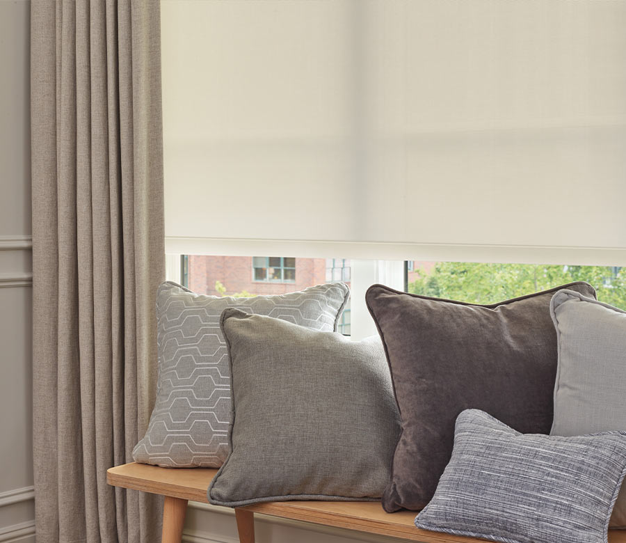 close up of pillows on bench with drapery panels in front of rolled down screen shade in Rocky River OH home
