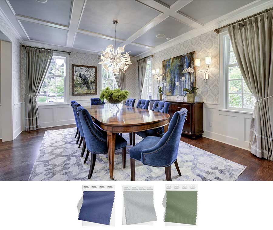 A beautiful, neutral dining room that has blue chairs, green curtains and a gray ceiling. They pair together to establish an elegant look