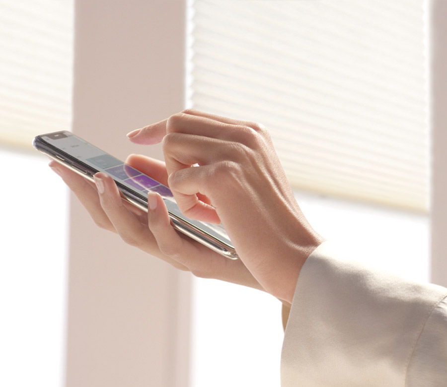 automated honeycomb shades being controlled by powerview mobile app