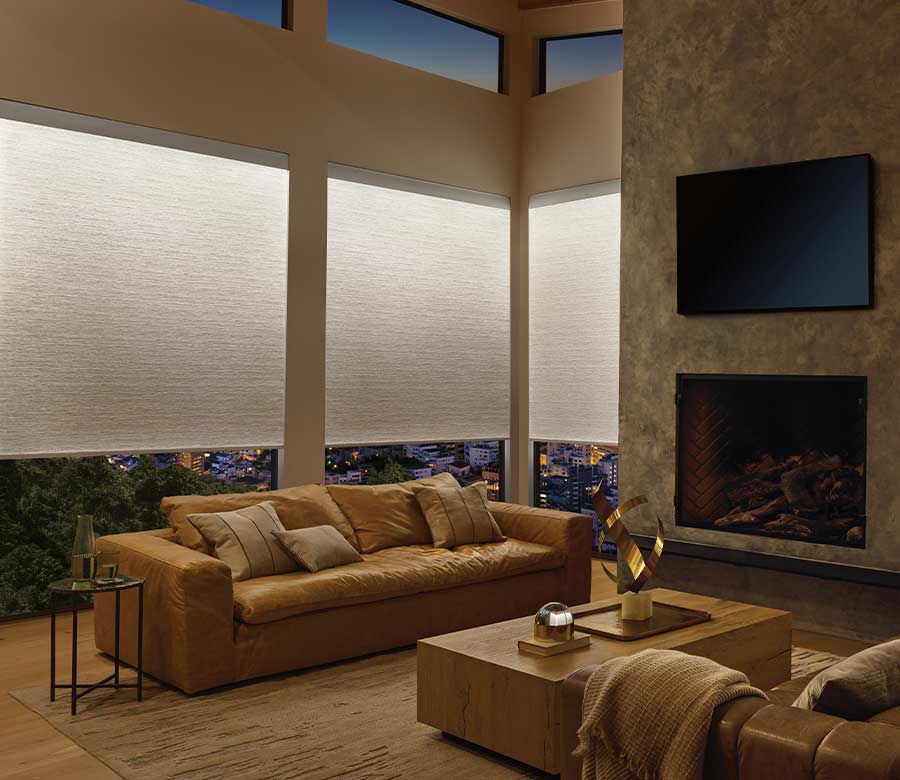 light illuminated window shades in a modern home and leather couches