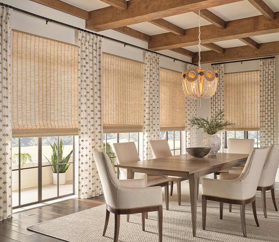 side drapery panels and window shades layered in a cozy modern dining room