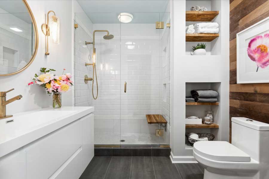 full bathroom with built-in wall storage for towels