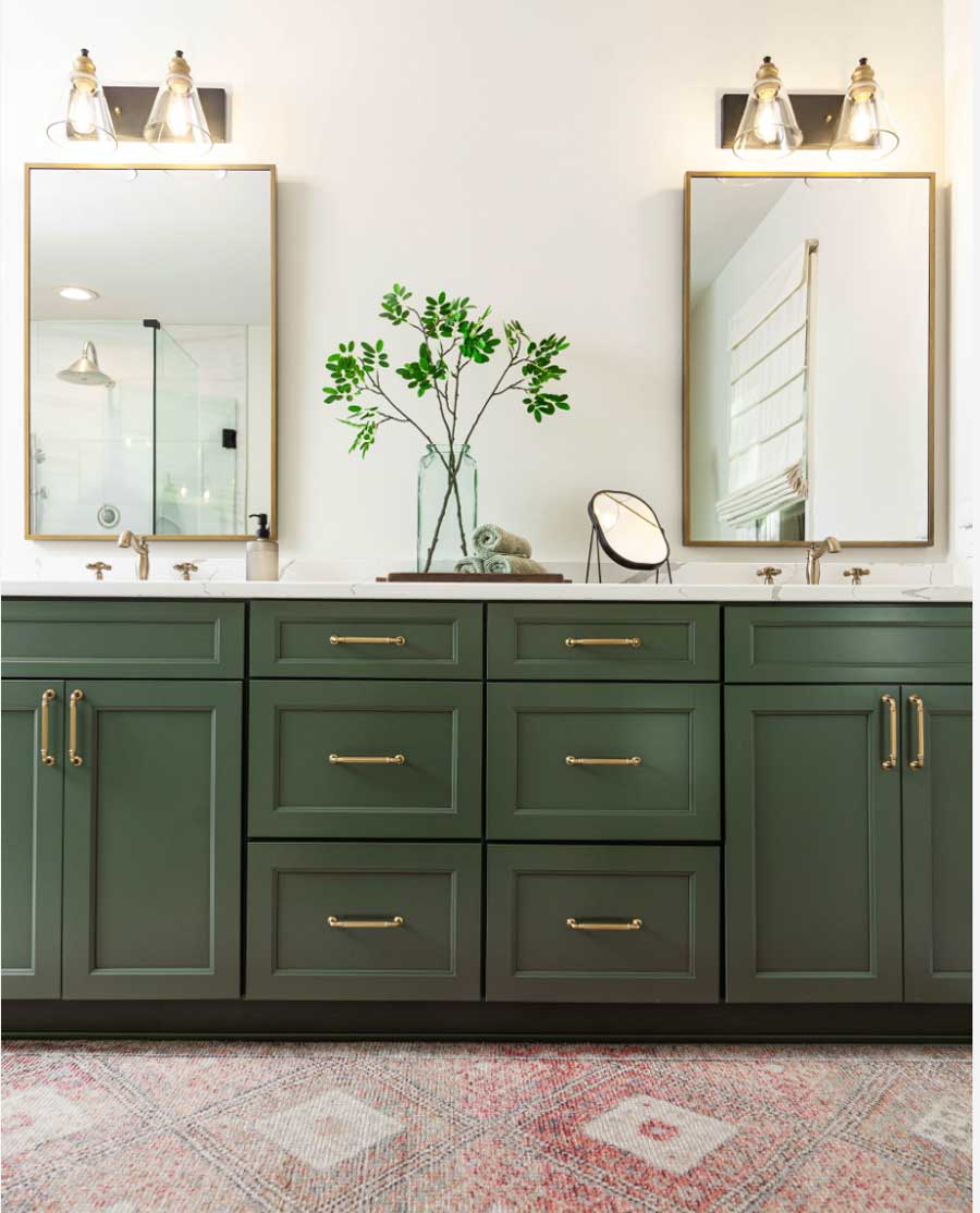 rich green vanity with gold rectangular mirrors