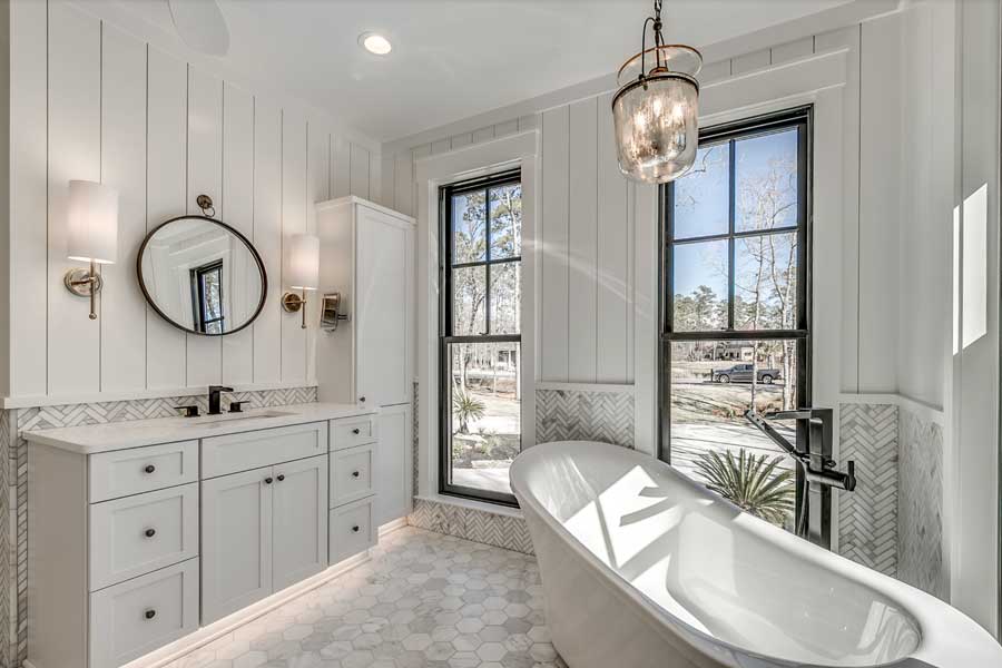 shiplap bathroom with hanging lights and sconces