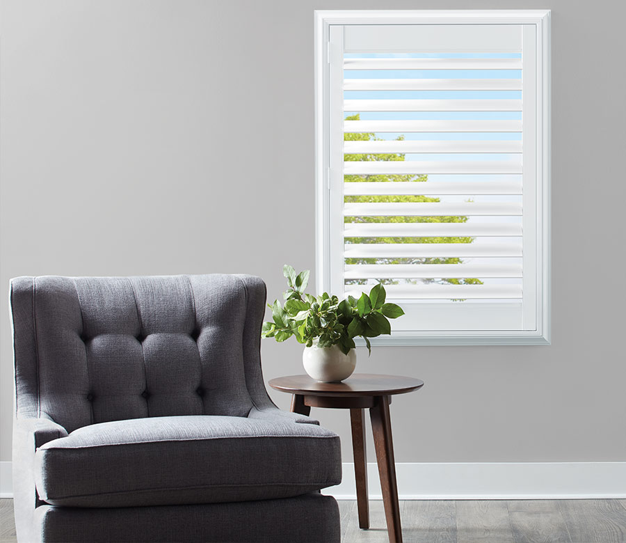 white composite shutter next to gray chair and potted plant