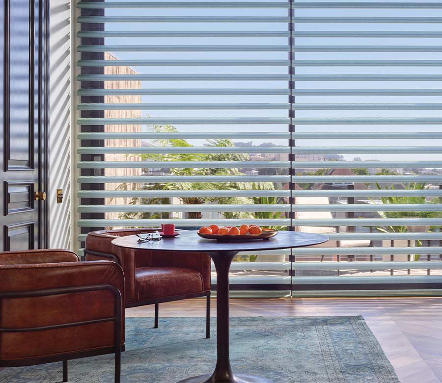 pirouette soft fabric shades in slate blue gray in modern dining space with outdoor view