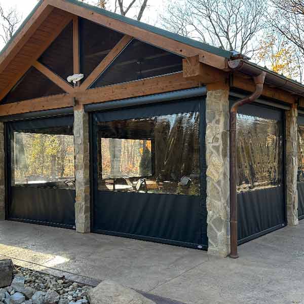exterior-shade-vinyl-screen-details-timan-window-treatments protect against windy conditions with outdoor shades on patio
