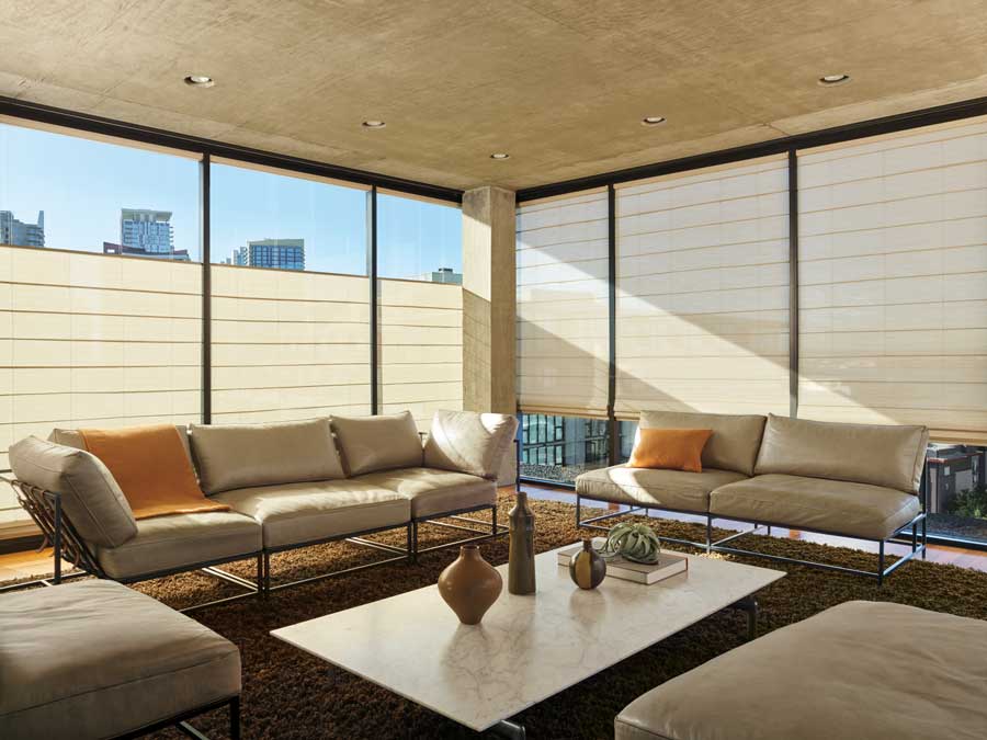 Floor to ceiling windows with Alustra® Woven Textures® Roman Shades in a neutral shade