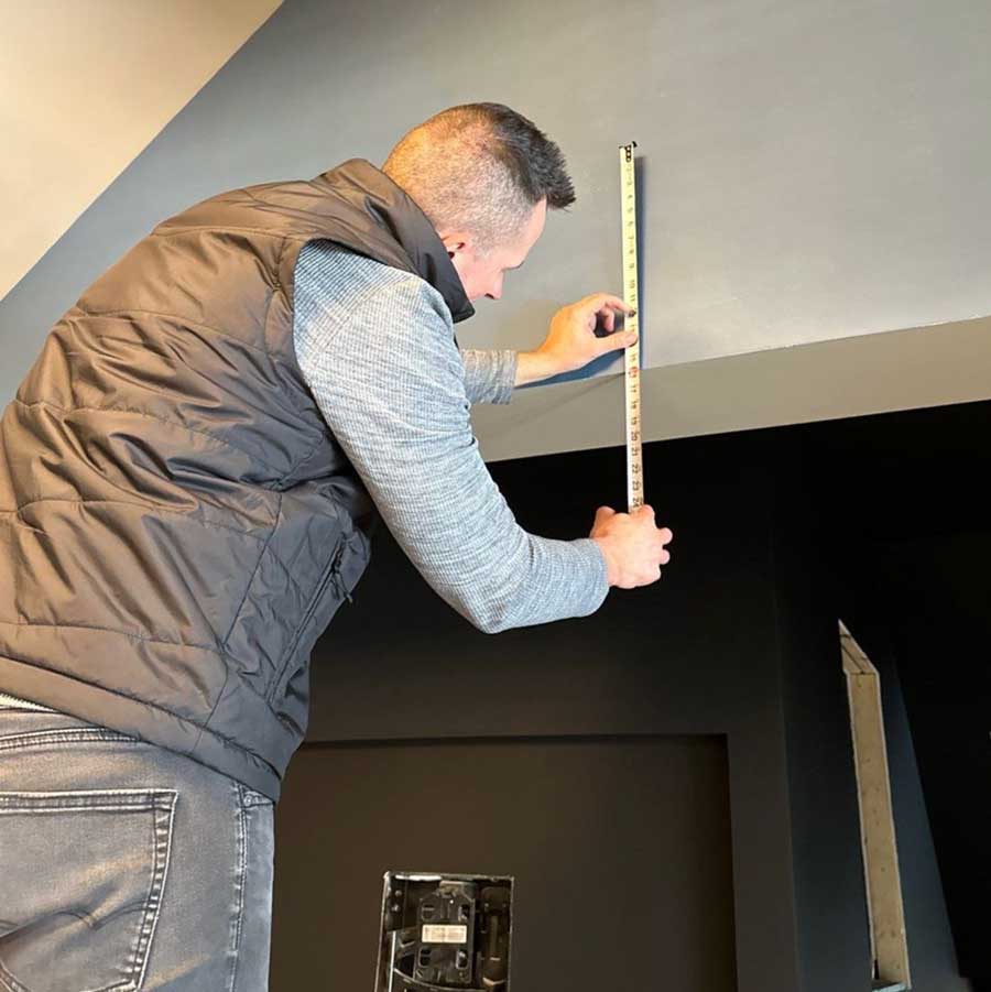 window covering measurements being taken by timan window treatments professional