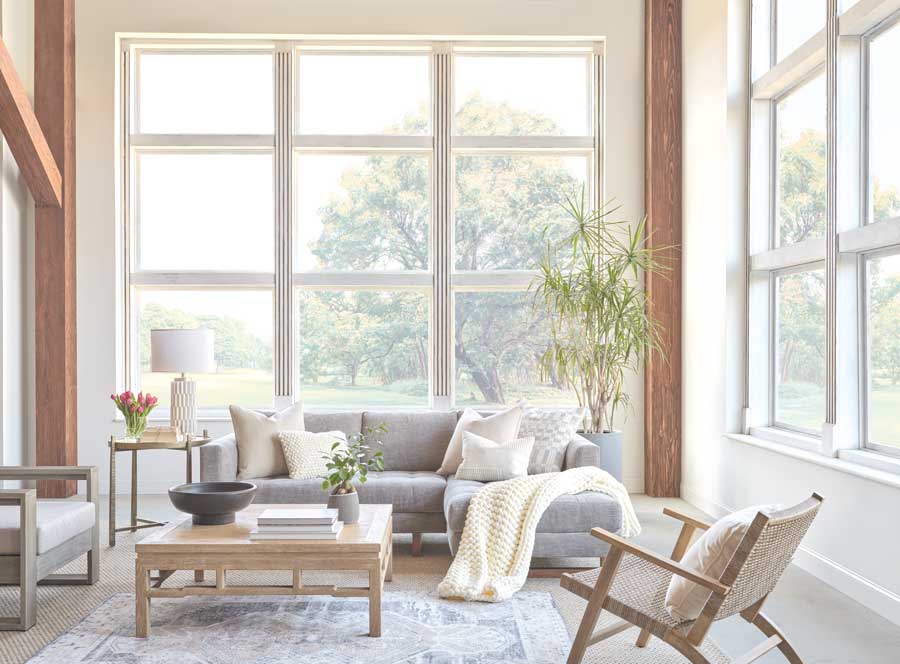 Tall living room windows with light trim and modern furniture