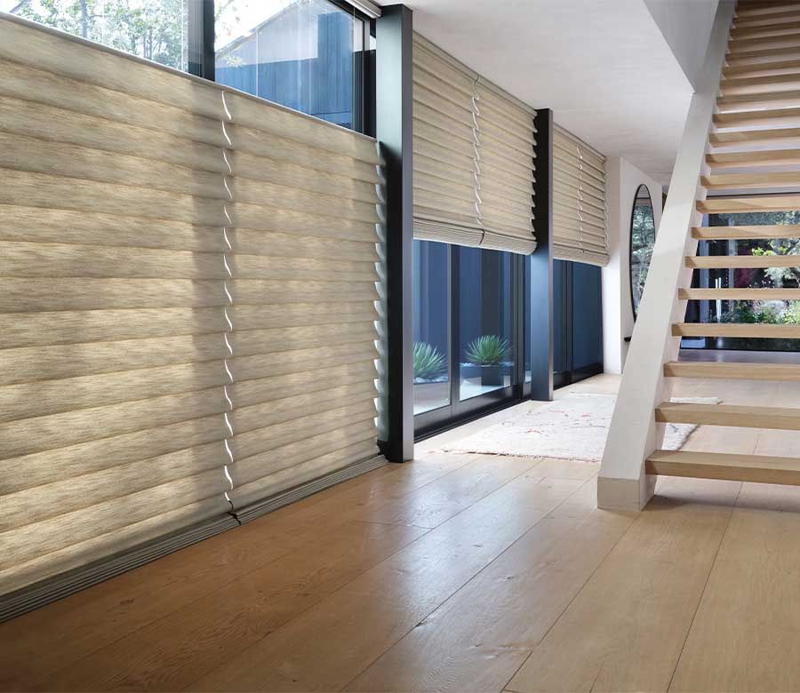 cordless thermal roman shades on tall windows next to staircase with top down bottom up feature