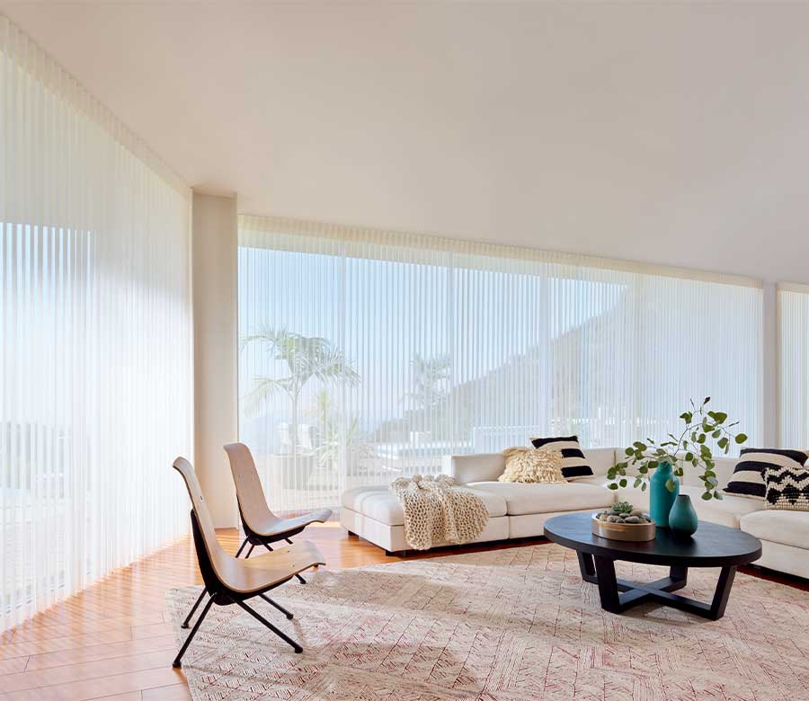 White vertical sheer blinds rotate vanes for view-through and room darkening options