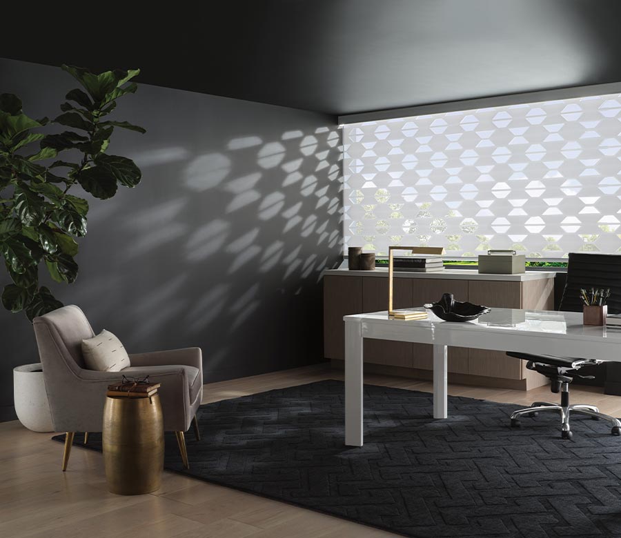 Hunter Douglas banded shades cover large window with geometric shaped fabric for feature wall in home office