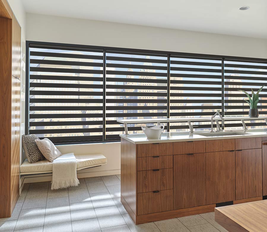 Zebra window blinds cover wall of windows in to rotate fabric layers in kitchen