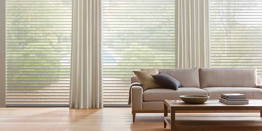 drapery pairing in a living area neutral with large windows